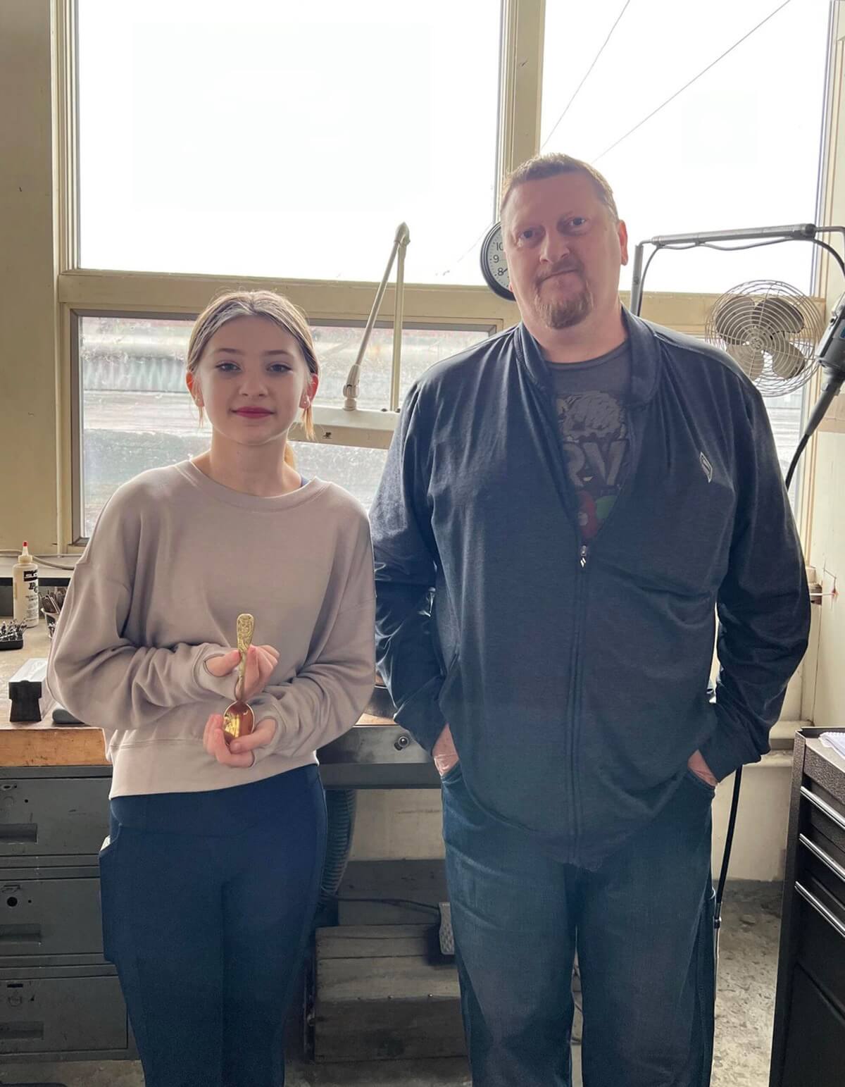 Isabella Lawrence with her Dad Eric Lawrence showing the Owl spoon design they created together. 