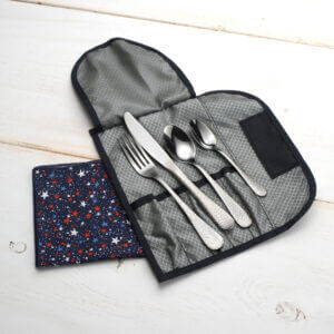 Travel cutlery set with flatware and napkin shown on a white background