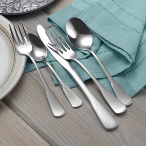 Candra flatware set shown on a decorative table