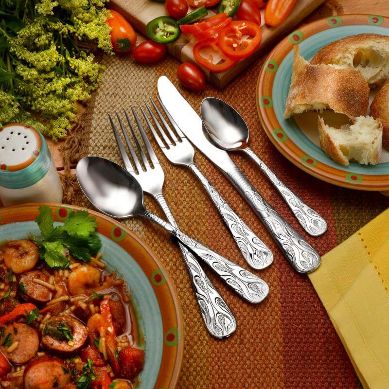 Flame fire flatware set shown on a decorative table..