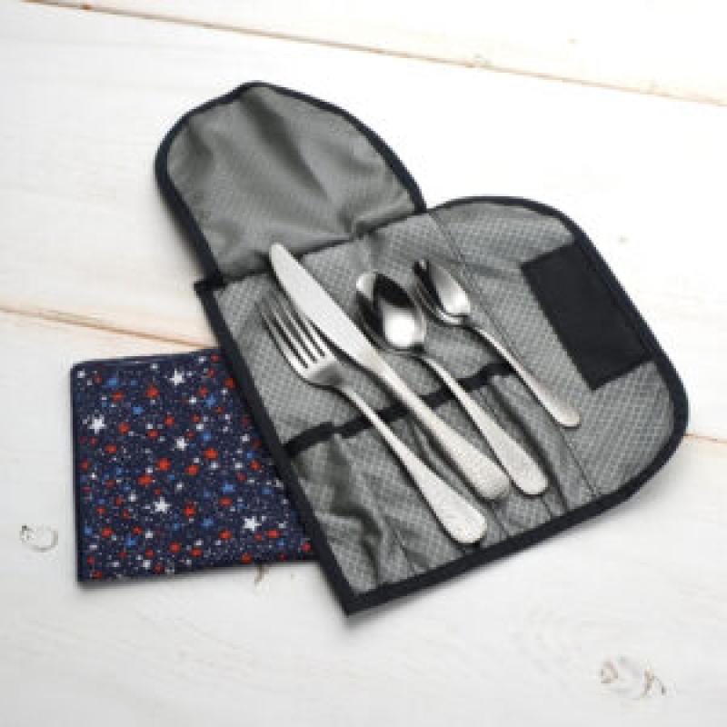 Cutlery travel pouch shown with flatware and a blue cloth napkin